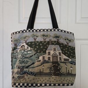 Tote bag. Home scene on front and solid black on back and bottom. Zipper closure